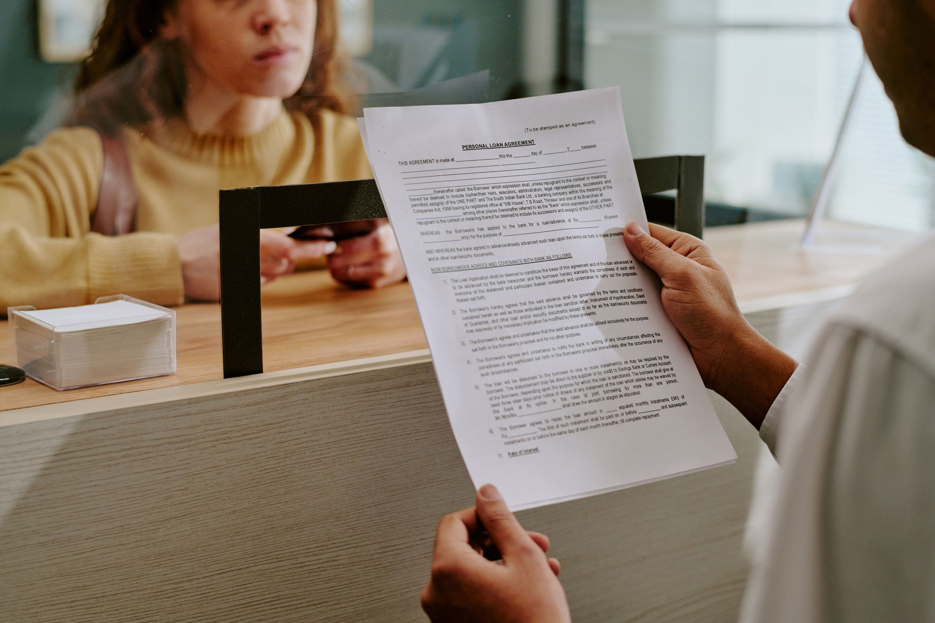 Reviewing Official Documents at Customer Service Counter